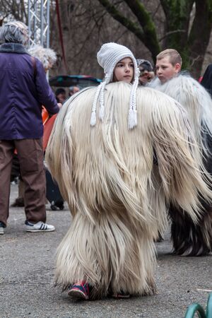 YAMBOL, BULGARIA - MARCH 08, 2015 - Kukerlandia - mask festival and masquerade games 08 March 2015. Bulgarian traditional dances and costumes called Kukeri.のeditorial素材