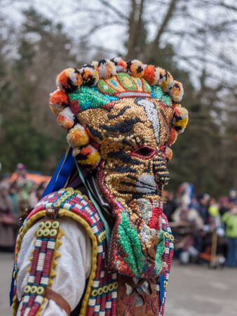 YAMBOL, BULGARIA - MARCH 08, 2015 - Kukerlandia - mask festival and masquerade games 08 March 2015. Bulgarian traditional dances and costumes called Kukeri.のeditorial素材