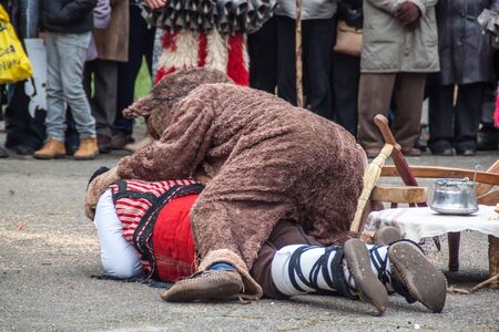 YAMBOL, BULGARIA - MARCH 08, 2015 - Kukerlandia - mask festival and masquerade games 08 March 2015. Bulgarian traditional dances and costumes called Kukeri.のeditorial素材