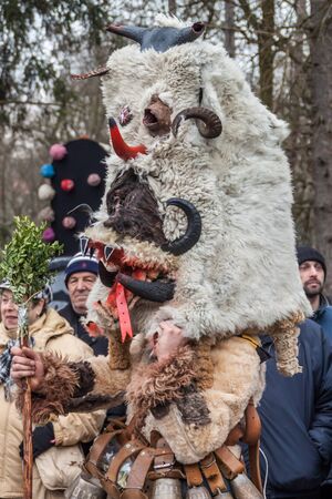 YAMBOL, BULGARIA - MARCH 08, 2015 - Kukerlandia - mask festival and masquerade games 08 March 2015. Bulgarian traditional dances and costumes called Kukeri.のeditorial素材