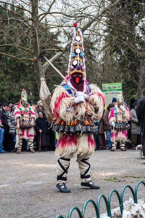 YAMBOL, BULGARIA - MARCH 08, 2015 - Kukerlandia - mask festival and masquerade games 08 March 2015. Bulgarian traditional dances and costumes called Kukeri.のeditorial素材