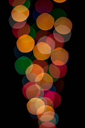 Cone shaped lights with different colors defocused and isolated on black background.の写真素材