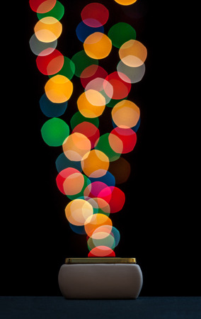 Collecting bokeh bubbles in a box. Isolated on black background.の写真素材