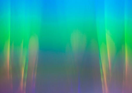 Light dispersion from a compact disk surface. Rainbow effect.
