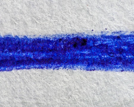 Extreme shot of a line drawn with a pen on a white paper.