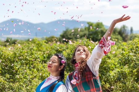 ROZOVO, BULGARIA - JUNE 06, 2015 - Rose picking ritual in Rozovo village. Girls throwing roses in the air as part of the celebrations.のeditorial素材