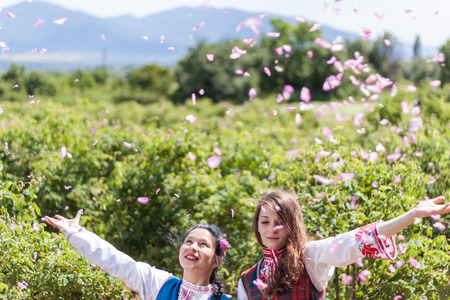 ROZOVO, BULGARIA - JUNE 06, 2015 - Rose picking ritual in Rozovo village. Girls throwing roses in the air as part of the celebrations.のeditorial素材