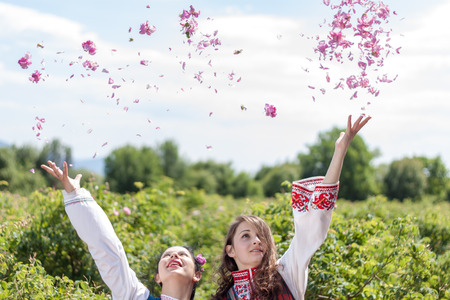 ROZOVO, BULGARIA - JUNE 06, 2015 - Rose picking ritual in Rozovo village. Girls throwing roses in the air as part of the celebrations.のeditorial素材