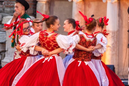 PLOVDIV, BULGARIA - AUGUST 06, 2015 - 21-st international folklore festival in Plovdiv, Bulgaria. The folklore group from Poland dressed in traditional clothing is preforming Polish national dances.のeditorial素材