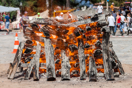Wood logs arranged as a stack set on fire.のeditorial素材