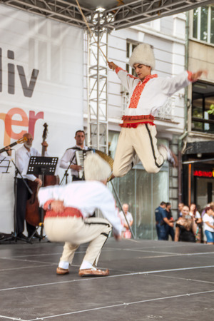 PLOVDIV, BULGARIA - AUGUST 06, 2015 - 21-st international folklore festival in Plovdiv, Bulgaria. The folklore group from Serbia dressed in traditional clothing is preforming Serbian national dances.のeditorial素材