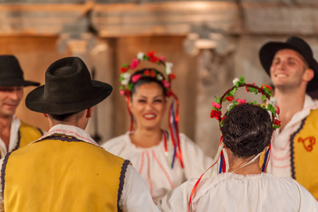PLOVDIV, BULGARIA - AUGUST 06, 2015 - 21-st international folklore festival in Plovdiv, Bulgaria. The folklore group from Serbia dressed in traditional clothing is preforming Serbian national dances.のeditorial素材