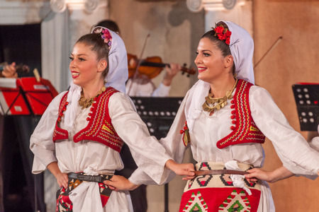 PLOVDIV, BULGARIA - AUGUST 06, 2015 - 21-st international folklore festival in Plovdiv, Bulgaria. The folklore group from Serbia dressed in traditional clothing is preforming Serbian national dances.のeditorial素材