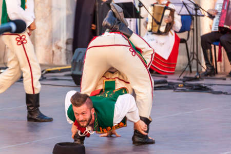 PLOVDIV, BULGARIA - AUGUST 06, 2015 - 21-st international folklore festival in Plovdiv, Bulgaria. The folklore group from Poland dressed in traditional clothing is preforming Polish national dances.のeditorial素材