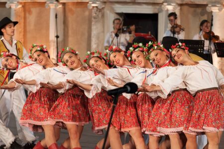 PLOVDIV, BULGARIA - AUGUST 06, 2015 - 21-st international folklore festival in Plovdiv, Bulgaria. The folklore group from Serbia dressed in traditional clothing is preforming Serbian national dances.のeditorial素材