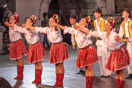 PLOVDIV, BULGARIA - AUGUST 06, 2015 - 21-st international folklore festival in Plovdiv, Bulgaria. The folklore group from Serbia dressed in traditional clothing is preforming Serbian national dances.のeditorial素材