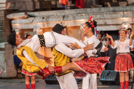 PLOVDIV, BULGARIA - AUGUST 06, 2015 - 21-st international folklore festival in Plovdiv, Bulgaria. The folklore group from Serbia dressed in traditional clothing is preforming Serbian national dances.のeditorial素材
