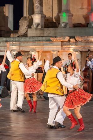 PLOVDIV, BULGARIA - AUGUST 06, 2015 - 21-st international folklore festival in Plovdiv, Bulgaria. The folklore group from Serbia dressed in traditional clothing is preforming Serbian national dances.のeditorial素材