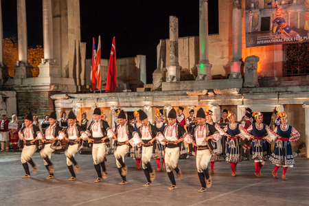 PLOVDIV, BULGARIA - AUGUST 06, 2015 - 21-st international folklore festival in Plovdiv, Bulgaria. The folklore group from Bulgaria dressed in traditional clothing is preforming Bulgarian national dances.のeditorial素材