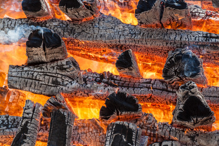 Wood logs arranged as a stack set on fire.の写真素材