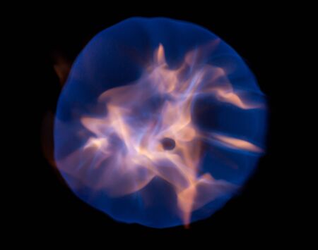 Fireball with blue flames isolated on black backgroundの写真素材