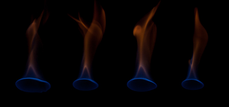 Blue and yellow colored flames isolated on black background