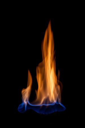 Blue and yellow colored flames isolated on black backgroundの写真素材