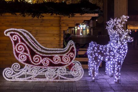 Brightly lit sleigh with two deers. Christmas decoration.の写真素材