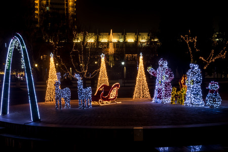 Santa Claus, Snow White and a sleigh with raindeers decorated with colorful Christmas lights.