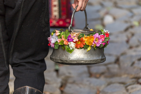 Bulgarian traditional pot called menche, decorated with some flowers