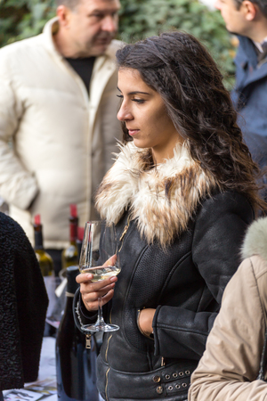 PLOVDIV, BULGARIA - NOVEMBER 29, 2015 - Young wine parade in the Old Town in Plovdiv, Bulgaria. Public wine tasting accompanied with traditional folklore dances.のeditorial素材