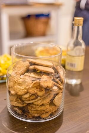 Big jar filled with cookies on a tableの写真素材