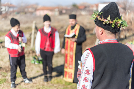 PERUSHTITSA, BULGARIA - FEBRUARY 14, 2015 - Recreating the ritual called Zariazvane in Perushtitsa, Bulgaria. People dressed in traditional clothing dance and cut the vineyards for fruitful harvest.のeditorial素材