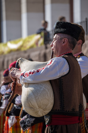 PERUSHTITSA, BULGARIA - FEBRUARY 14, 2015 - Recreating the ritual called Zariazvane in Perushtitsa, Bulgaria. People dressed in traditional clothing dance and cut the vineyards for fruitful harvest.のeditorial素材