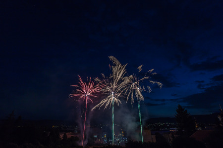 Fireworks display over the town of Panagyurishte, Bulgaria with blue sky in the background.の写真素材