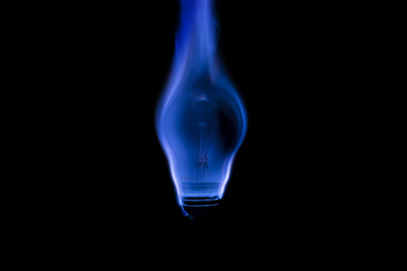 Tungsten light bulb burning with a beautiful blue flameの写真素材