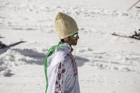 PAMPOROVO, BULGARIA - MARCH 03, 2017 - Skiing with Bulgarian flags at Pamporovo, Bulgaria. People dressed with traditional bulgarian clothes skiing with the national flag.のeditorial素材