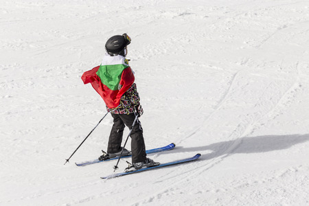 PAMPOROVO, BULGARIA - MARCH 03, 2017 - Skiing with Bulgarian flags at Pamporovo, Bulgaria. People dressed with traditional bulgarian clothes skiing with the national flag.のeditorial素材