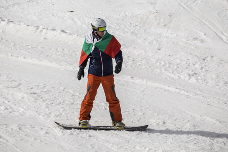 PAMPOROVO, BULGARIA - MARCH 03, 2017 - Skiing with Bulgarian flags at Pamporovo, Bulgaria. People dressed with traditional bulgarian clothes skiing with the national flag.のeditorial素材