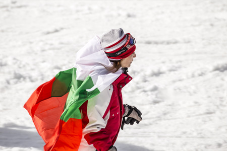 PAMPOROVO, BULGARIA - MARCH 03, 2017 - Skiing with Bulgarian flags at Pamporovo, Bulgaria. People dressed with traditional bulgarian clothes skiing with the national flag.のeditorial素材