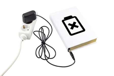 Book connected to a USB charger. Battery symbol indicating the charge level.の写真素材