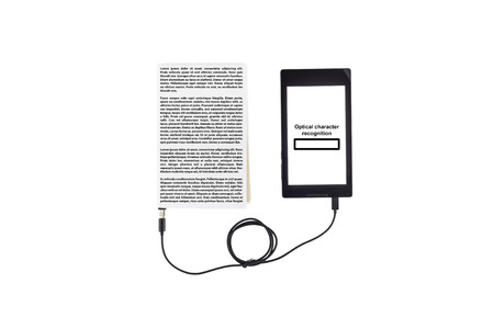Book connected to a tablet through an USB cable. Optical character recognition loading bar.の写真素材