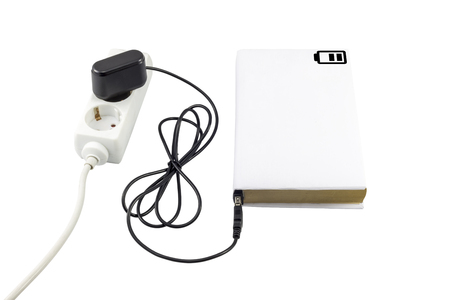 Book connected to a USB charger. Battery symbol indicating the charge level.の写真素材