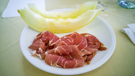 Traditional Italian dish - melon and prosciutto ham.の写真素材