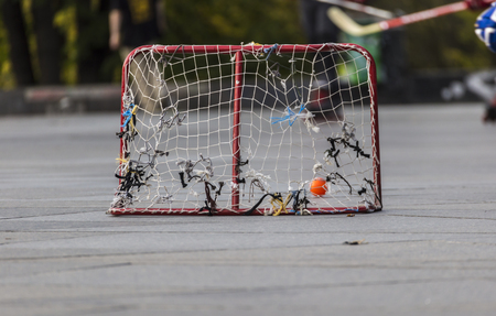 People palying street hockey with rolerblades. Low angle view.