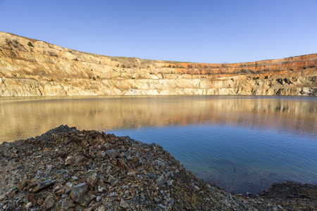 At the bottom of abandoned mining crater with water near Tsar Asen village in Bulgariaの写真素材