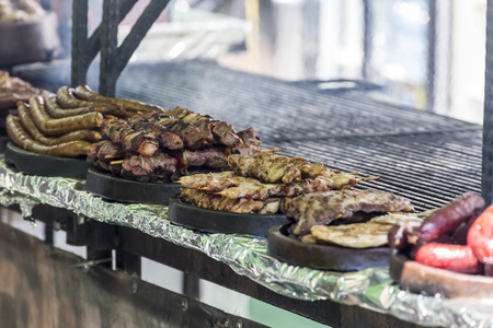 Many different barbecue meats and sausages on a grillの写真素材