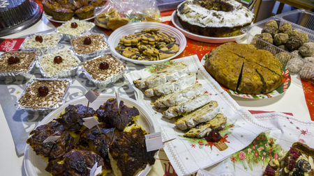 Rich table spread with many different dishes, fruits and deserts.の写真素材