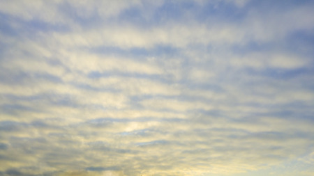 Beautiful wavy pattern clouds in the sky during sunsetの写真素材