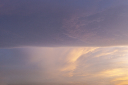 Straight line cloud spliting the sky in half. Rectangle square shaped cloud.の写真素材